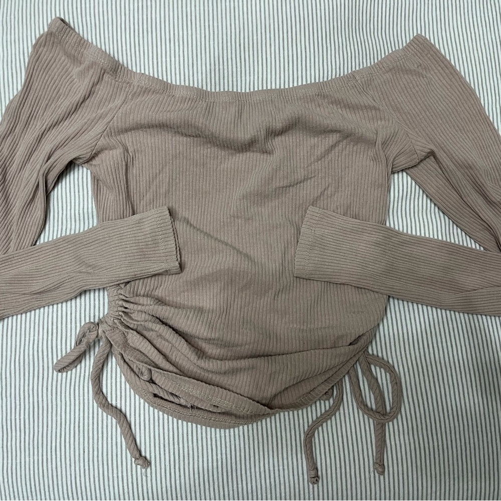 Trendy long sleeve top. Circles for design on sides.